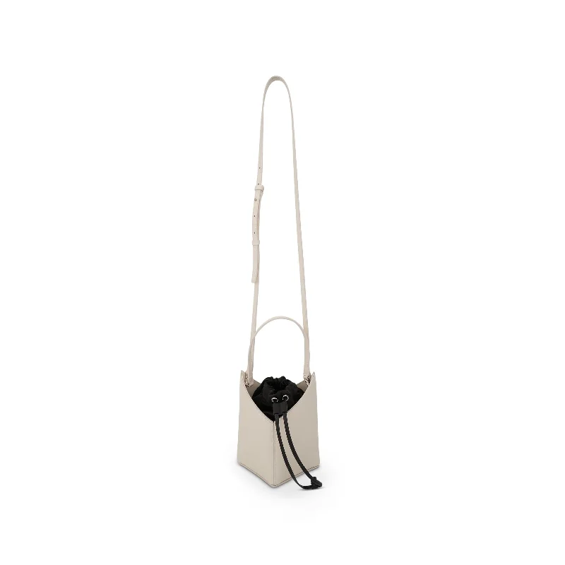 PVC Bucket Bag in Clear with Glitter Accents for a Fun and Edgy StyleMini Cut Out Bucket Bag in Box Leather in Ivory
