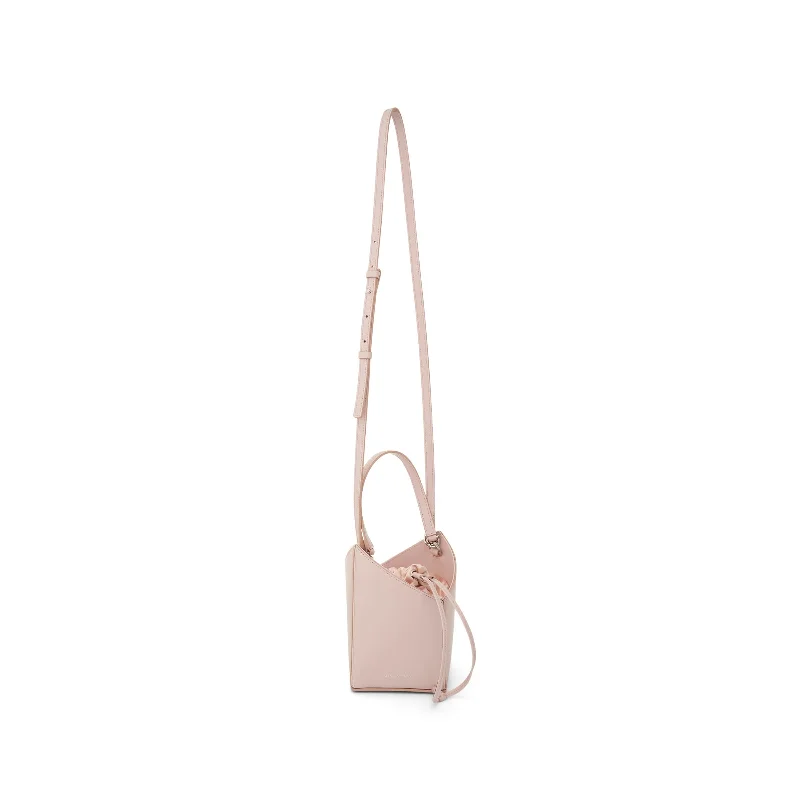 Suede Bucket Bag in Burgundy with Tassel Trim for a Boho - Chic VibeMini Cut Out Bucket Bag in Box Leather in Light Pink